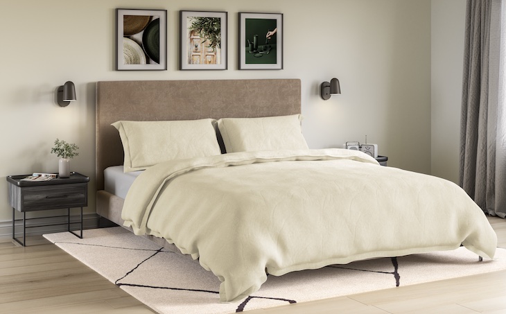 bed with bed frame legs covered by comforter