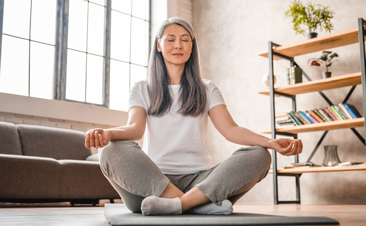 person meditating at home