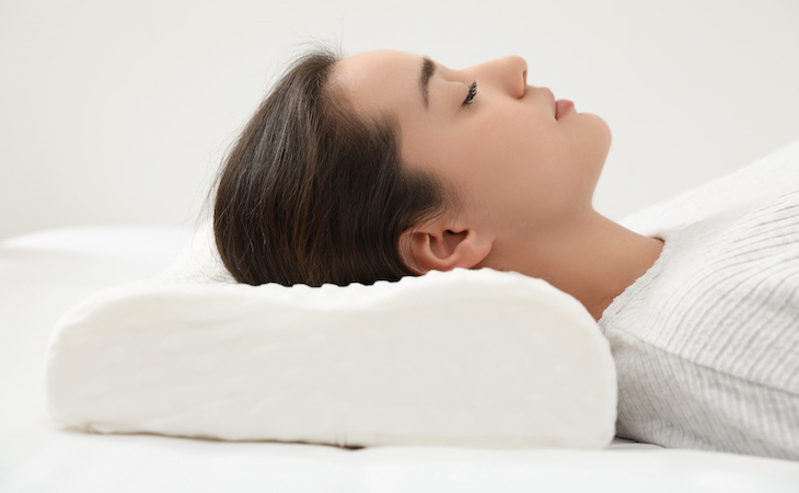 person sleeping on a cervical pillow