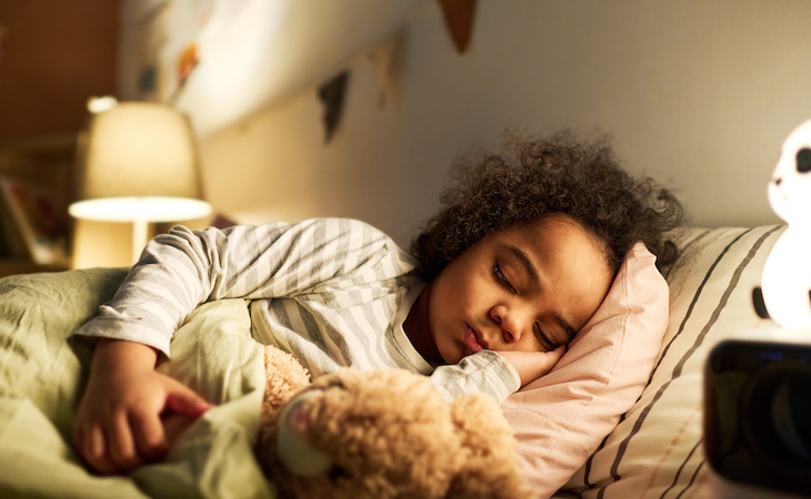 little child sleeping in bed