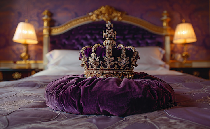 purple velvet crown on top of bed