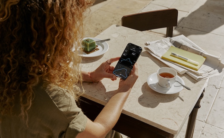 person wearing oura ring looking at phone